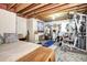 Unfinished basement offers potential with exposed ceiling and workout equipment at 2685 S Dayton Way # 141, Denver, CO 80231