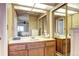 Bathroom vanity with a mirror and mirrored sliding doors to the closet at 2685 S Dayton Way # 141, Denver, CO 80231