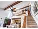 Great room with ceiling fan connects kitchen with living area and features wood beams and an upper loft at 2685 S Dayton Way # 141, Denver, CO 80231