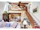 Inviting living room boasts soaring ceilings, a cozy loft, and a charming staircase at 2685 S Dayton Way # 141, Denver, CO 80231