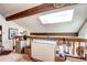Bright loft space featuring a skylight, exposed beams, and ample storage space at 2685 S Dayton Way # 141, Denver, CO 80231