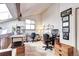 Versatile loft space with vaulted ceiling, wood beam, natural light, and built-in storage at 2685 S Dayton Way # 141, Denver, CO 80231