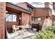 The cozy patio features a grill, brick facade, and outdoor seating area at 2685 S Dayton Way # 141, Denver, CO 80231