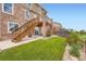 Spacious backyard with well-maintained lawn, elevated deck, and room for recreation at 19431 E Wyoming Ave, Aurora, CO 80017