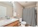 Neutral bathroom featuring a single sink vanity, toilet, and shower with curtain at 19431 E Wyoming Ave, Aurora, CO 80017