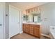Spacious bathroom with a double vanity, large mirror, and modern lighting fixtures at 19431 E Wyoming Ave, Aurora, CO 80017