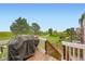 Relaxing deck view overlooking a lush green meadow with walking paths and mature trees at 19431 E Wyoming Ave, Aurora, CO 80017