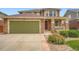 Beautiful exterior featuring a green garage door, stone accents, and a manicured lawn at 19431 E Wyoming Ave, Aurora, CO 80017