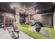 Modern home gym with astroturf, workout equipment and custom lighting for fitness enthusiasts at 19431 E Wyoming Ave, Aurora, CO 80017