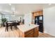 Spacious kitchen featuring an island, black appliances, and open floor plan to dining and living room at 19431 E Wyoming Ave, Aurora, CO 80017