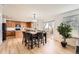 Open concept kitchen and dining with wood floors, bright light, and access to outdoor patio at 19431 E Wyoming Ave, Aurora, CO 80017