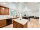 Modern kitchen with an island, stainless steel appliances, and an open layout to the dining area at 19431 E Wyoming Ave, Aurora, CO 80017