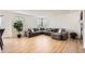 Large living room with an oversized sectional sofa, hardwood floors, and an abundance of natural light at 19431 E Wyoming Ave, Aurora, CO 80017