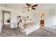 Bright main bedroom with a wood accent bedframe, ceiling fan, and neutral decor at 19431 E Wyoming Ave, Aurora, CO 80017