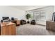 Well-lit office featuring a desk, chairs, large windows, and stylish decor at 19431 E Wyoming Ave, Aurora, CO 80017