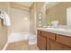 This full bathroom features a tub shower combo, tile floors, and a white vanity at 20166 E Shady Ridge Rd, Parker, CO 80134