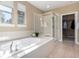 Relaxing bathroom features a soaking tub, a separate glass-enclosed shower, and walk-in closet at 20166 E Shady Ridge Rd, Parker, CO 80134