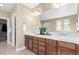 Double sink vanity in a primary bathroom featuring a large mirror and ample cabinet space at 20166 E Shady Ridge Rd, Parker, CO 80134