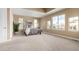 Bright bedroom with neutral tones, multiple windows, tray ceiling and soft carpet at 20166 E Shady Ridge Rd, Parker, CO 80134