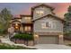 Lovely two-story home with stone accents, a two-car garage, and manicured landscaping at 20166 E Shady Ridge Rd, Parker, CO 80134