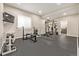This home gym features weights, a weight rack, and a television for your workout needs at 20166 E Shady Ridge Rd, Parker, CO 80134