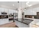 Modern kitchen with white cabinets, stainless steel appliances, and black countertops is designed for functionality at 20166 E Shady Ridge Rd, Parker, CO 80134
