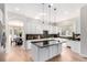 Well-lit kitchen boasts an island with dark countertops, perfect for food preparation and casual dining at 20166 E Shady Ridge Rd, Parker, CO 80134