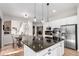 Gourmet kitchen with stone backsplash, stainless steel appliances, an island, and an attached breakfast nook at 20166 E Shady Ridge Rd, Parker, CO 80134