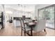 Eat-in kitchen features wooden table, chairs, and sliding glass door overlooking the outdoor space at 20166 E Shady Ridge Rd, Parker, CO 80134