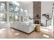 Open-concept living room featuring a stone fireplace, floor-to-ceiling windows, and modern furnishings at 20166 E Shady Ridge Rd, Parker, CO 80134