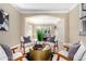 Cozy living room with stylish chairs, a unique gold coffee table, and an open view to the dining area at 20166 E Shady Ridge Rd, Parker, CO 80134