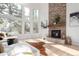 Bright living room with a stone fireplace, tall windows, hardwood floors, and comfortable seating at 20166 E Shady Ridge Rd, Parker, CO 80134