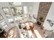 Spacious living room with a stone fireplace, floor-to-ceiling windows, and a comfortable sofa at 20166 E Shady Ridge Rd, Parker, CO 80134