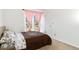 Cozy bedroom with brown bedding and large window at 5769 S Nepal Ct, Centennial, CO 80015