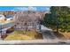 Gray house with a landscaped yard and attached garage at 5769 S Nepal Ct, Centennial, CO 80015