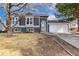 Gray siding house with a 2-car garage and landscaped yard at 5769 S Nepal Ct, Centennial, CO 80015