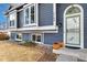 Front entrance with green door and landscaping at 5769 S Nepal Ct, Centennial, CO 80015