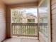 Cozy balcony offers a view of a neighboring home through large windows and a wooden railing at 1120 Opal St # 203, Broomfield, CO 80020