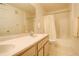 Bright bathroom features double sinks, a large mirror, and a shower-tub combination at 1120 Opal St # 203, Broomfield, CO 80020