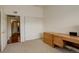 Functional bedroom features carpeted floors, built-in desk, and a closet for ample storage at 1120 Opal St # 203, Broomfield, CO 80020