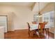 Cozy dining area featuring hardwood floors, large windows, and a classic chandelier at 1120 Opal St # 203, Broomfield, CO 80020