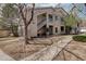 Inviting two-story condo building with blue stair accents, lush landscaping, and a well-maintained walkway at 1120 Opal St # 203, Broomfield, CO 80020