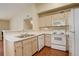 Efficient kitchen with white appliances, ample counter space, and wood cabinets for a functional design at 1120 Opal St # 203, Broomfield, CO 80020
