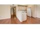 Open-concept kitchen with white appliances, wood cabinets, and breakfast bar, perfect for entertaining at 1120 Opal St # 203, Broomfield, CO 80020