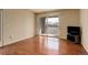 Bright living room with hardwood floors, sliding glass doors to a balcony, and neutral paint at 1120 Opal St # 203, Broomfield, CO 80020