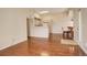 Open-concept living area showcasing hardwood floors, neutral tones, dining table and kitchen view at 1120 Opal St # 203, Broomfield, CO 80020