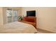 Relaxing bedroom with carpet flooring, a dresser, and a sliding door that leads to the balcony at 1120 Opal St # 203, Broomfield, CO 80020