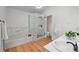 Bright bathroom with a soaking tub, glass-enclosed shower, double sinks, and modern fixtures at 5716 S Lisbon Way, Centennial, CO 80015