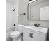 Bright bathroom featuring white tiles, contemporary fixtures, and a stylish mirror at 5716 S Lisbon Way, Centennial, CO 80015
