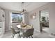 Elegant dining room with a stylish light fixture, seating for four, and abundant natural light at 5716 S Lisbon Way, Centennial, CO 80015